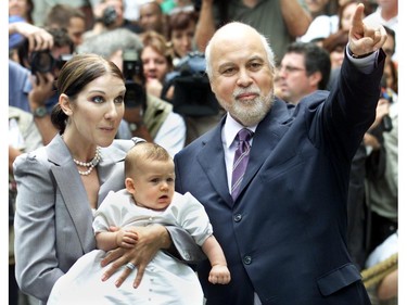 Céline Dion carries son Rene-Charles out of chapel at Notre Dame Basilica with husband Rene Angélil after baptism on July 25, 2001.