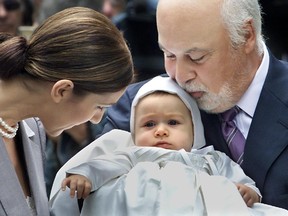 René Angélil  and Céline Dion enter the Notre Dame Basilica's chapel with their son René-Charles  July 25, 2001 for the baby's baptism.
