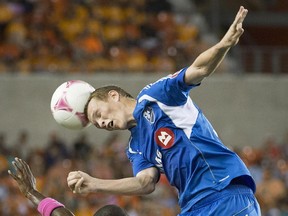 Montreal Impact midfielder Wandrille Lefevre wins a header against Houston Dynamo midfielder Boniek Garcia during second half of an MLS game on Oct. 4, 2013, in Houston.