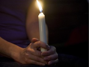 MONTREAL, JUNE 14, 2012: A woman holds a candle at a vigil. [THE GAZETTE/Graham Hughes]