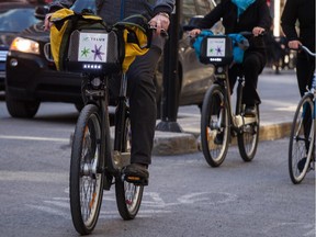 Cyclists ride Bixi bicycles.