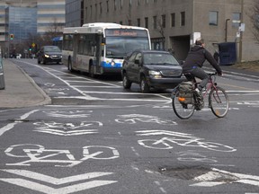 A cyclist uses the bike path at the intersection of de Maisonneuve Blvd. and Décarie  St. in Montreal in April.