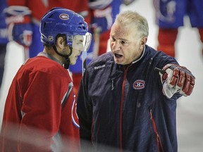 Canadiens coach Michel Therrien speaks with Alex Galchenyuk during practice at the team's training facility in Brossard on April 30, 2015.
