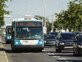 STM buses drive southbound on St. Jean Blvd.