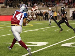 Alouettes receiver Brandon London gets behind Ottawa Red Blacks defenders for a long gain on pass from quarterback  Jonathan Crompton during game at Montreal's Molson Stadium on Aug. 29, 2014.