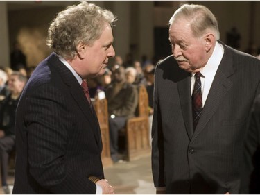 Premier Jean Charest (left) speaks to former premier Jacques Parizeau at a Special Eucharistic celebration for victims of the January earthquake in Haiti Saturday, January 23, 2010 at St. Joseph's Oratory in Montreal.