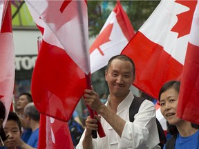 Participants celebrate at the Canada Day Parade  in downtown Montreal, Tuesday July 1, 2014.