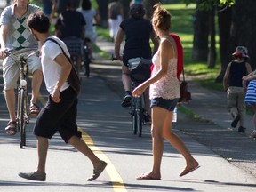 A pedestrian dashes across between bikes on a bicycle path.