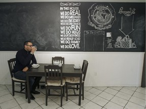 Ali Benryane has coffee under a wall-sized chalkboard in the kitchen his condo in Little Burgundy.