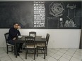 Ali Benryane has coffee under a wall-sized chalkboard in the kitchen his condo in Little Burgundy.