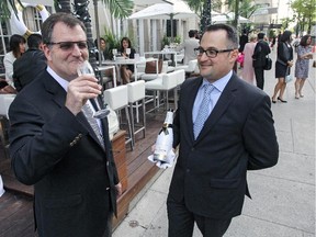 Ritz-Carlton Hotel CEO and general manager Andrew Torriani, left, enjoys a glass of Champagne poured by Cyril Dupont, manager of Maison Boulud at the hotel's launch of its Moet & Chandon Beach, in conjunction with this week's F1 Grand Prix in Montreal on Wednesday, June 3, 2015.
