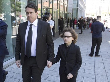 Parti Québécois leader Pierre Karl Péladeau and his son Thomas leave the Caisse de Dépot, after they payed their respects to former Quebec Premier Jacques Parizeau which lies in state in Montreal, on Saturday June 06, 2015. The state funeral will be held Tuesday in Montreal.