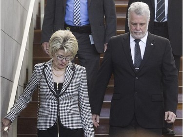 Quebec Premier Philippe Couillard and his wife Suzanne Pilote leave the Caisse de dépôt et placement du Québec, after paying their respects to former premier Jacques Parizeau on Saturday June 6, 2015.