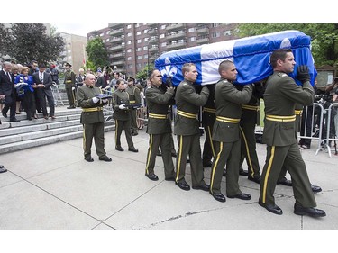 Lisette Lapointe, wife of the former Quebec Premier Jacques Parizeau, and family members, march behind the coffin, being carried out of Saint-Germain d'Outremont Church by SQ honour guard following the state funeral in Montreal on Tuesday June 09, 2015.