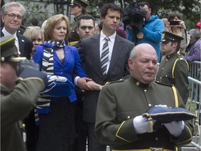 Lisette Lapointe, wife of the former Quebec Premier Jacques Parizeau, and family members, march behind the coffin as it is carried from Saint-Germain d'Outremont Church by an SQ honour guard following the state funeral in Montreal on Tuesday June 09, 2015.