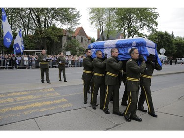 The coffin of former Quebec Premier Jacques Parizeau, is carried into the church by SQ honour  guard at the start of the state funeral in Montreal on Tuesday June 09, 2015.