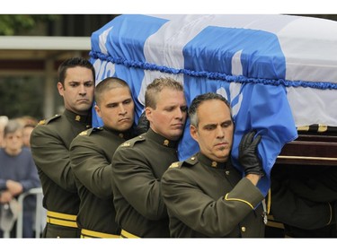 The coffin of former Quebec Premier Jacques Parizeau, is carried into the church by SQ honour guard at the start of the state funeral in Montreal on Tuesday June 09, 2015.