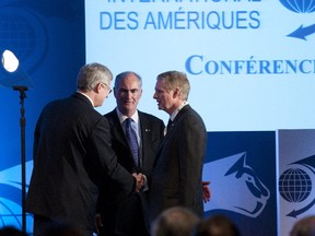 Prime Minister Stephen Harper greets conference founder Gil Rémillard, centre, and Paul Desmarais Jr. after speaking at the International Economic Forum of the Americas in 2012.