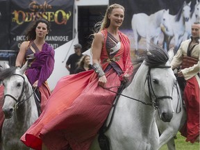 Elise Verdoncq, centre, and other members of the Cavalier Odysséo horse show, participate in promotional event outside Montreal city hall on Thursday, June 11, 2015.