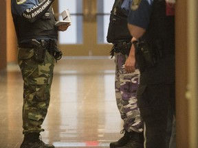 Special constables who work at the Montreal courthouse wear camouflage pants and jeans as part of pressure tactics in labour negotiations in Montreal, on Thursday, June 11, 2015.