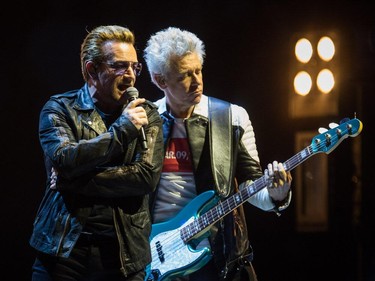 Bono, left, and Adam Clayton, right, of the Irish rock band U2 perform at the Bell Centre as part of their iNNOCENCE + eXPERIENCE Tour in Montreal on Friday, June 12, 2015.