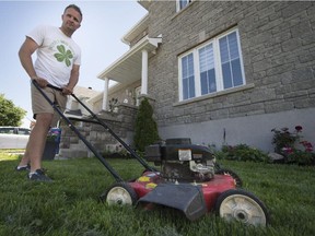 Kevin Beasse in front of his Vaudreuil-Dorion home on Sunday, June 14, 2015. Beasse received a $270 ticket from public security for mowing his lawn on a Sunday afternoon after 4 p.m.