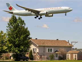 Airplanes fly over houses on Marler Ave. in Dorval.