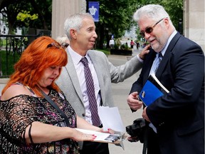 Gary Shapiro, centre, is seen with Brent Tyler and Antoinette after reacting to the proposed Quebec sign law changes in Montreal on Wednesday, June 17, 2015.