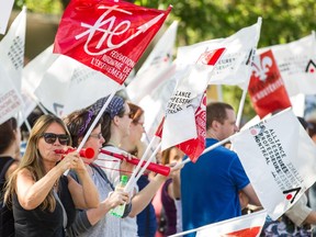 Teachers protest against budget cuts outside the Commission scolaire de Montréal building.