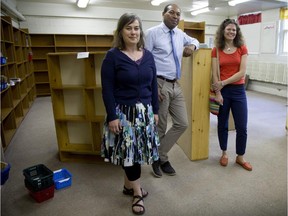 Julia Stark head librarian, Otis Delaney, principal at Elizabeth Ballentyne School, and  Tanya Radhakrishna, who is co-chair of the board of directors of the Montreal West Children's LIbrary, stand amid the library's  renovations in Montreal West, Thursday, June 18, 2015.