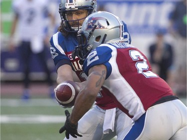 Montreal Alouettes quarterback Jonathan Crompton hands off ball to Brandon Whitaker, during first half of pre-season CFL football action in Montreal on Thursday June 18, 2015 against the Toronto Argonauts.