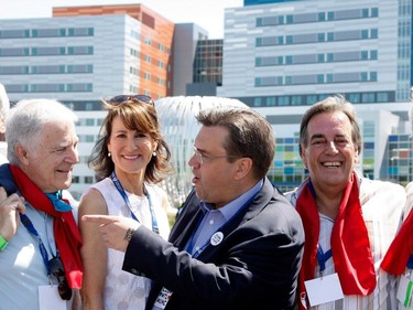 Montreal Mayor Denis Coderre, centre, jokes with Claudio Bussandri, chairman of the MUCH board, during the Walk for Montreal to inaugurate the new MUHC Glen site in Montreal on Saturday June 20, 2015. Quebec Immigration Minster Kathleen Weil, second from left,and Normand Rinfret look on.