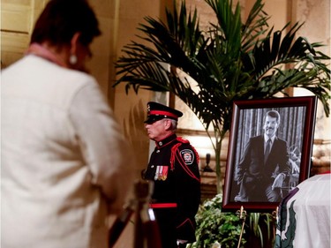 A member of the public pays her respects to Jean Doré as he lies in state in the Hall of Honour at Montreal city hall on Sunday June 21, 2015.
