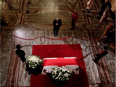 A pays his last respect to Jean Doré as he lies in state in the Hall of Honour at Montreal city hall on Sunday June 21, 2015.