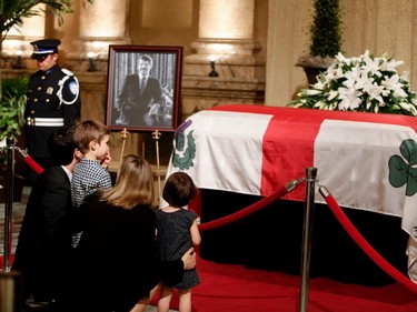 Amélie Duceppe, the daughter of former mayor Jean Doré, and her family pay their respects to former mayor Jean Doré in the Hall of Honour at Montreal city hall on Sunday June 21, 2015.