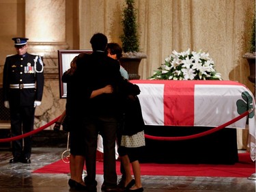 Amélie Duceppe, the daughter of former mayor Jean Doré, and her family pay their respects to former mayor Jean Dor¾© in the Hall of Honour at Montreal city hall on Sunday June 21, 2015.