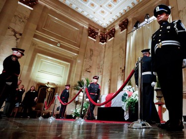 Members of the public wait as the honour guard changes as Jean Doré lies in state in the Hall of Honour at Montreal city hall on Sunday June 21, 2015.