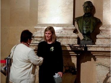 Under the bust of Jacques Viger, Montreal's first mayor who served from 1833-1836, Amélie Duceppe greets the public during visitation for Jean Doré in the Hall of Honour at Montreal city hall on Sunday June 21, 2015. Former Montreal mayor