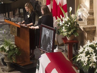 Daughters Amélie Duceppe, left, and Magali Doré speak at the funeral of their father and former Montreal mayor Jean Doré, during service at Montreal city hall on  Monday June 22, 2015.