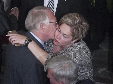 Former mayor of Montreal Gérald Tremblay gives a hug to Anie Samson before the funeral service of former Montreal mayor Jean Doré, at city hall in  Montreal on Monday June 22, 2015.