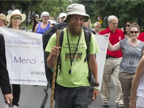 Ian Bos walks with volunteers and staff of the  West Island Palliative Care Residence in Kirkland on Monday, June 22, 2015.  He was on the Montreal leg of his walk across Canada - from New Glasgow, N.S., to Victoria, B.C. - to raise funds and awareness for palliative care.