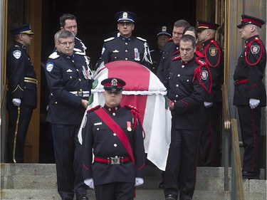 The coffin carrying the body of Jean Doré, is taken down the steps of city hall by members of the Montreal police and firefighters, following service at Montreal city hall on Monday June 22, 2015.