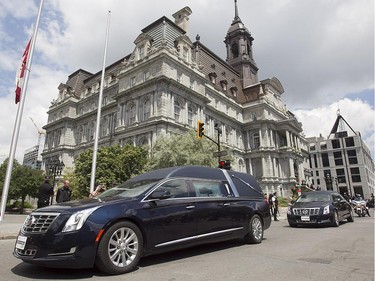 The funeral cortege carrying the body of former Montreal mayor Jean Doré, leaves Montreal city hall following service on Monday June 22, 2015.