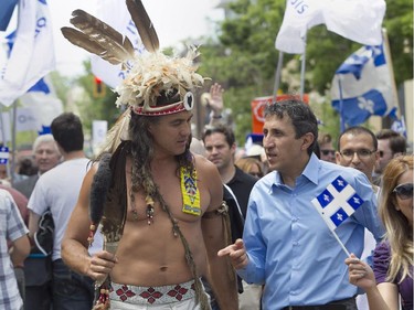 Amir Khadir (right), spokesperson for Québec Solidaire talks with Stuart Myiow, Wolf clan representative in the Mohawk tradional council of Kahnawake at the Fête nationale parade on Wednesday, June 24, 2015 in Montreal.