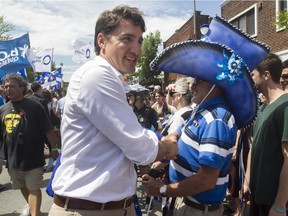 Federal Liberal leader Justin Trudeau greets people at the Fête nationale parade on Wednesday, June 24, 2015 in Montreal.