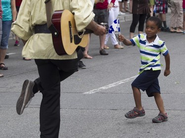 Jaydens  Méthélus has a dance with a participant in the Fête nationale parade on Wednesday, June 24, 2015 in Montreal.