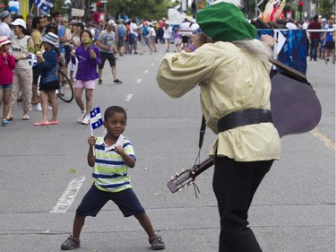 Jaydens  Méthélus has a dance with a participant in the Fête nationale parade on St. Denis St. Wednesday, June 24, 2015 in Montreal.
