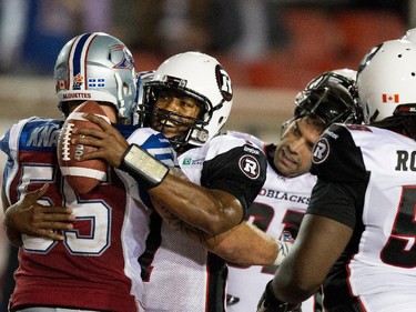 Montreal Alouettes defensive end Gabriel Knapton, left, congratulates Ottawa Redblacks quarterback Henry Burris after the Redblacks beat the Alouettes 20-16 during CFL action at the Percival Molson Stadium in Montreal on Thursday June 25, 2015.