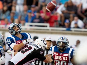 Montreal Alouettes quarterback Jonathan Crompton gets hit by Ottawa Redblacks wide receiver Scott Macdonell during CFL action at the Percival Molson Stadium in Montreal on Thursday June 25, 2015. Crompton failed to make the pass and allowed an interception on the play.