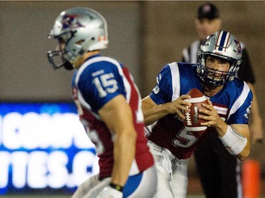 Montreal Alouettes quarterback Dan LeFevour, right, runs the ball against the Ottawa Redblacks during CFL action at the Percival Molson Stadium in Montreal on Thursday June 25, 2015. LeFevour was hurt on the play and did not return to the field. The Redblacks beat the Alouettes 20-16.